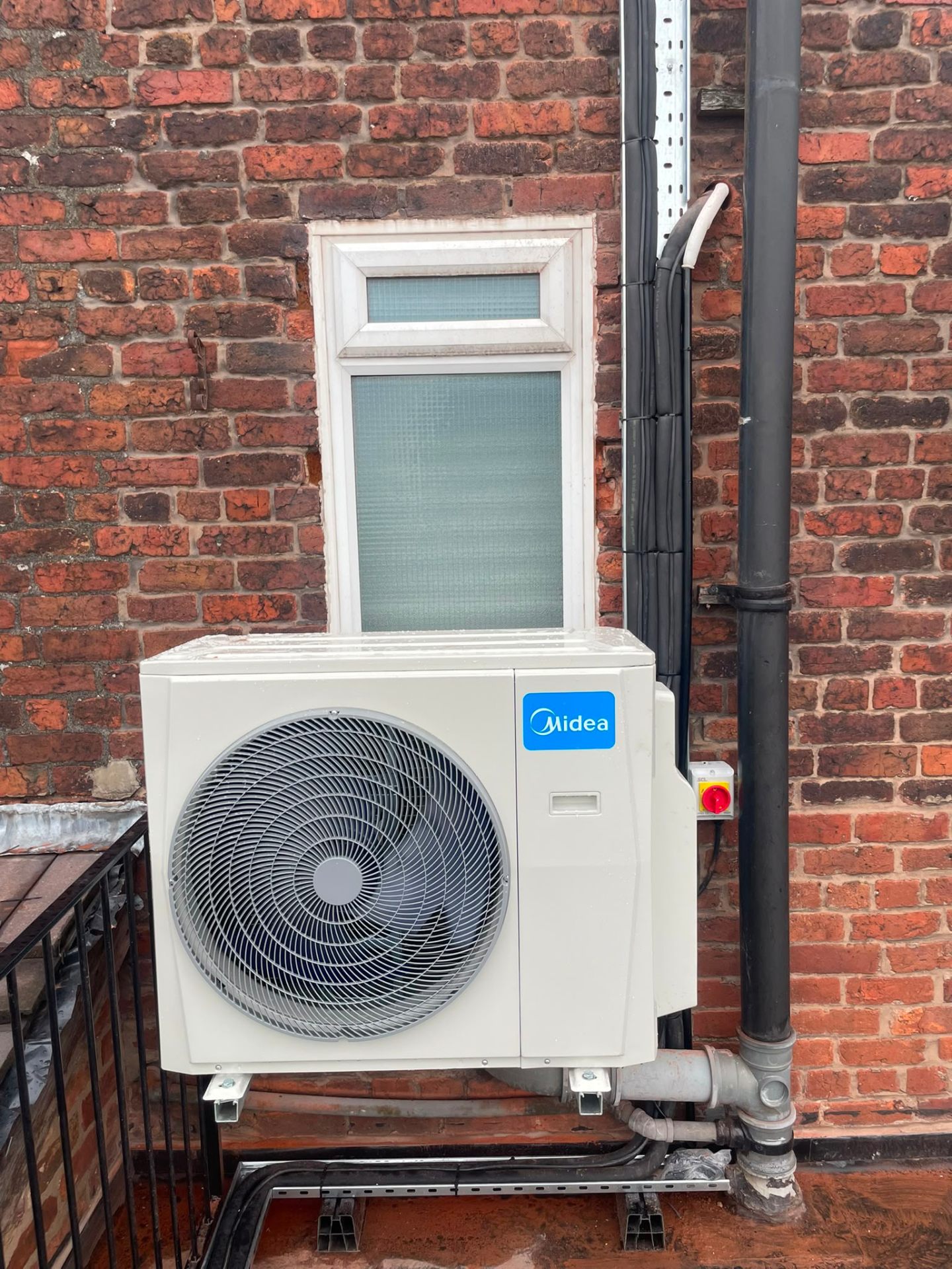 Mitsubishi Electric wall-mounted air conditioning unit installed in a Manchester domestic living room by JC Heating and Cooling.