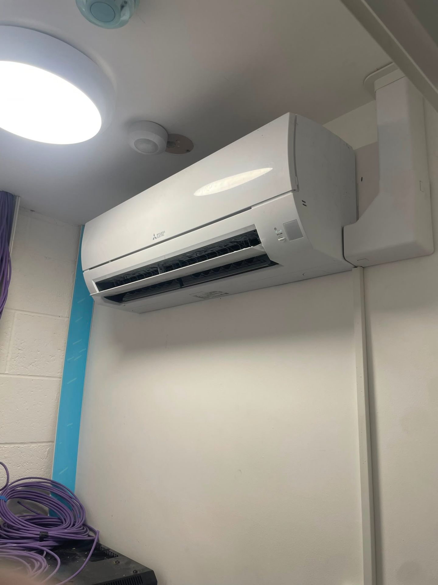 Mitsubishi Electric wall-mounted split installed in a clean commercial interior, North West.
