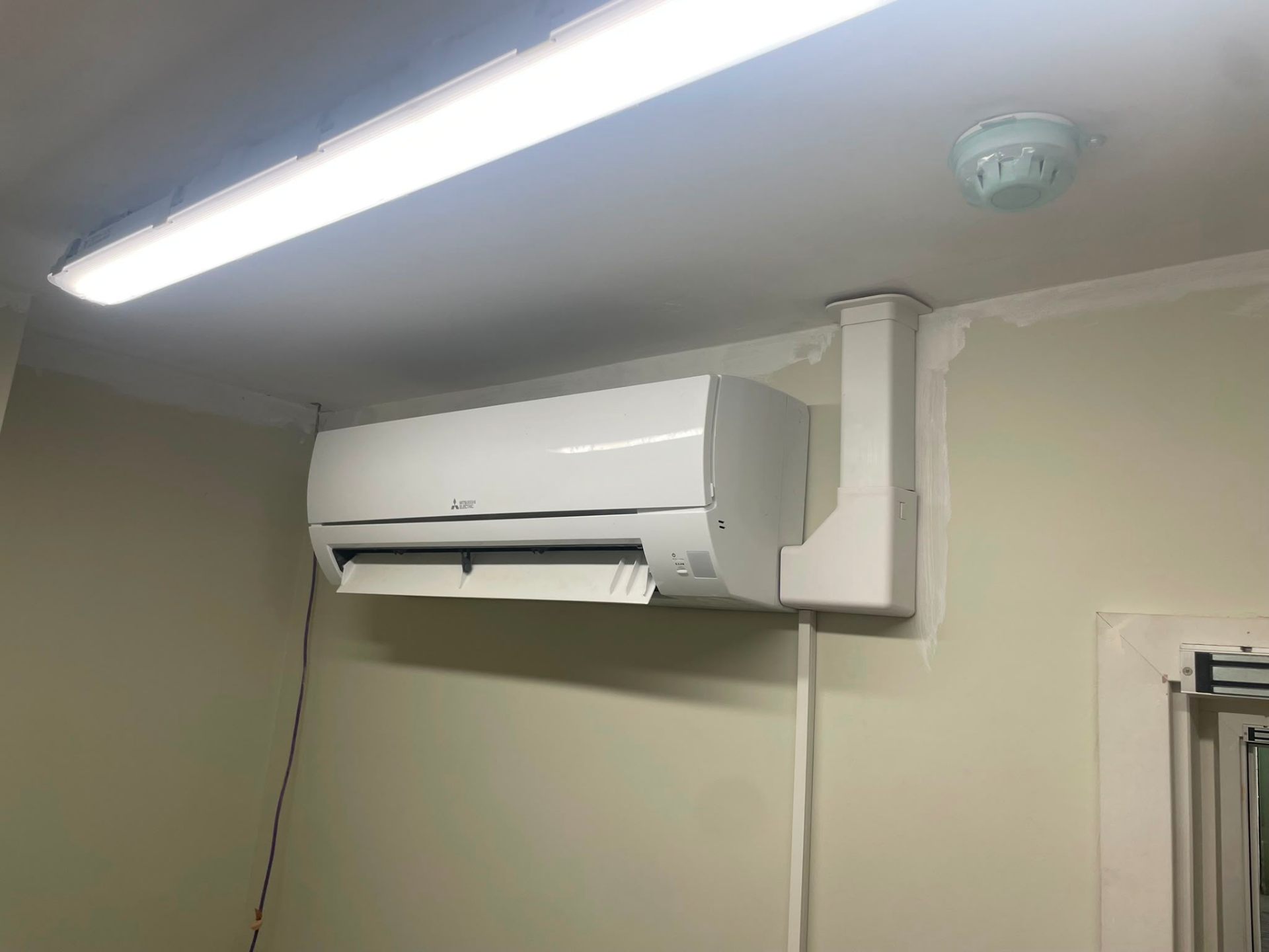 Cleanly serviced indoor air conditioning unit with brushed filters after planned HVAC maintenance.